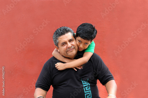 Single grandfather latino and grandchild play and have fun together spending quality family time on Father's Day celebrating victory with hugs and kisses
 photo