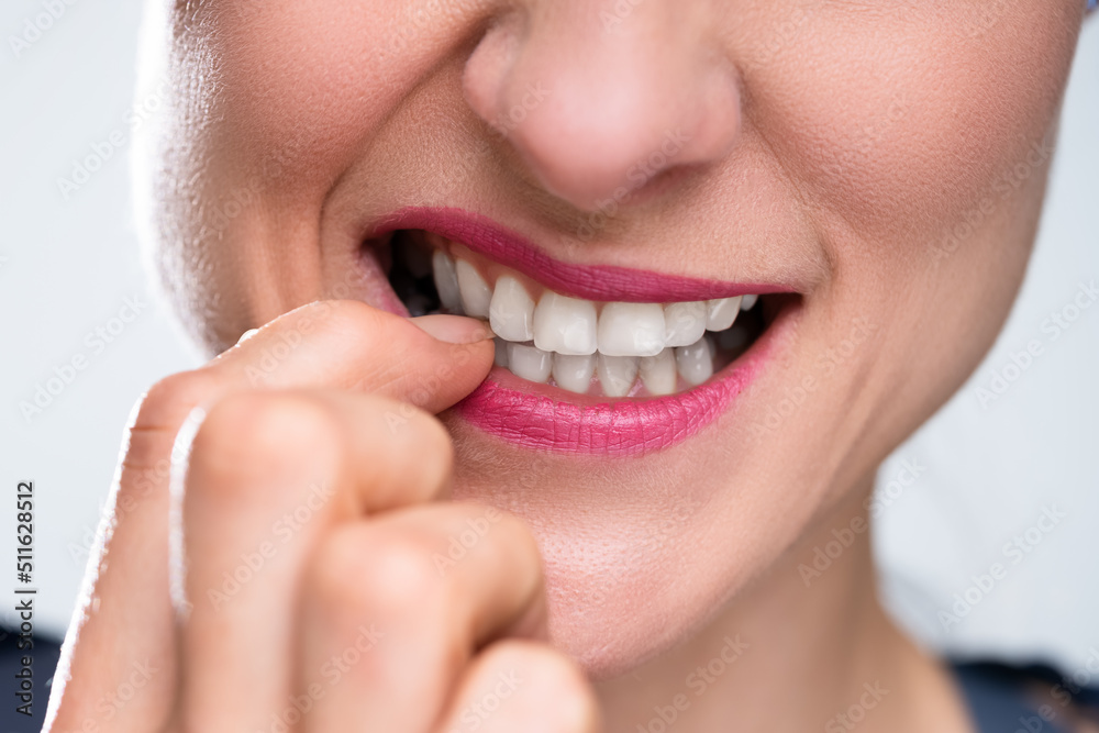 Obraz premium Businesswoman Biting Her Fingernail