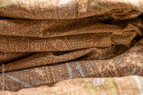 Pieces of fabric with different patterns, stacked. Close-up, selective focus