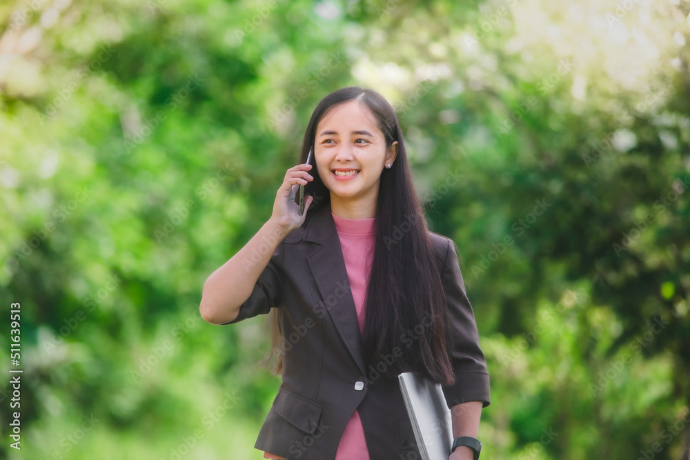 business woman Standing on the phone in the park beside the town business woman Standing on the phone in the park beside the town