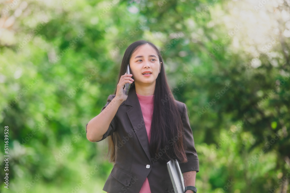 business woman Standing on the phone in the park beside the town business woman Standing on the phone in the park beside the town
