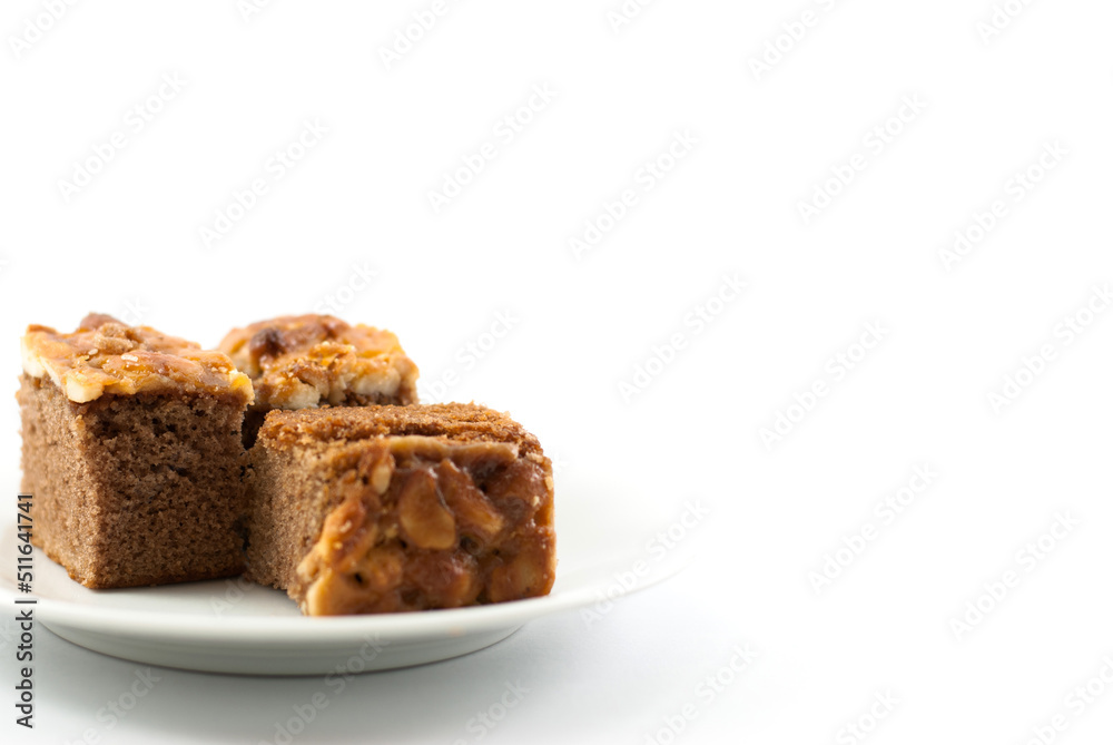 Toffee cake in white ceramic plate on a white background.