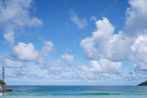 White clouds in blue sky over blue sea water landscape summer greeting background