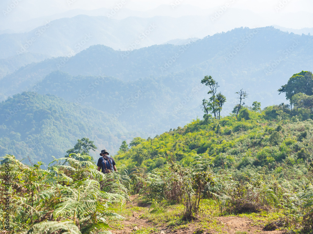 Trekking solo backpack on mountain trail in tropical forest at Tak Province, Thailand. Trekking solo backpack on mountain trail in tropical forest at Tak Province, Thailand.