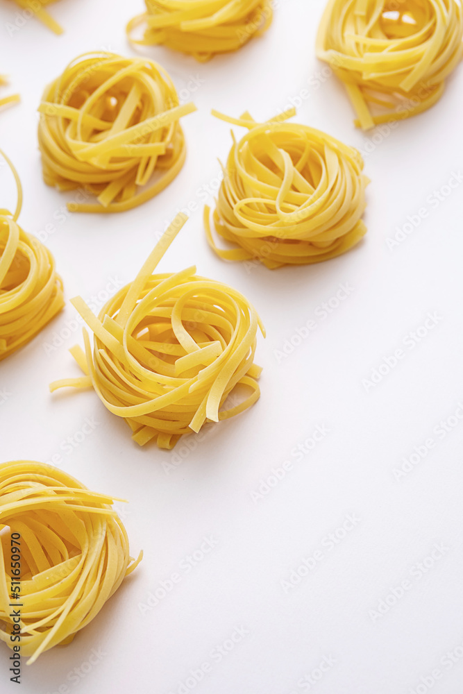 Homemade raw twisted pasta on pink table. Mediterranean food background. Homemade raw twisted pasta on pink table. Mediterranean food background.