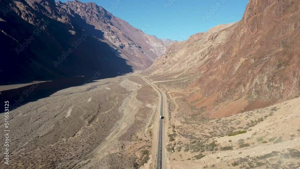 Ruta 7 through the Andes mountains between Chile and Argentina with a truck on the road and mountains on both sides