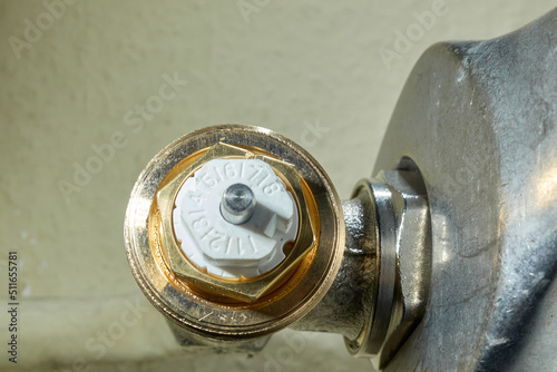 Install Heimeier thermostatic valve. Open-end wrench screws component to the old radiator. Modernize heating systems.