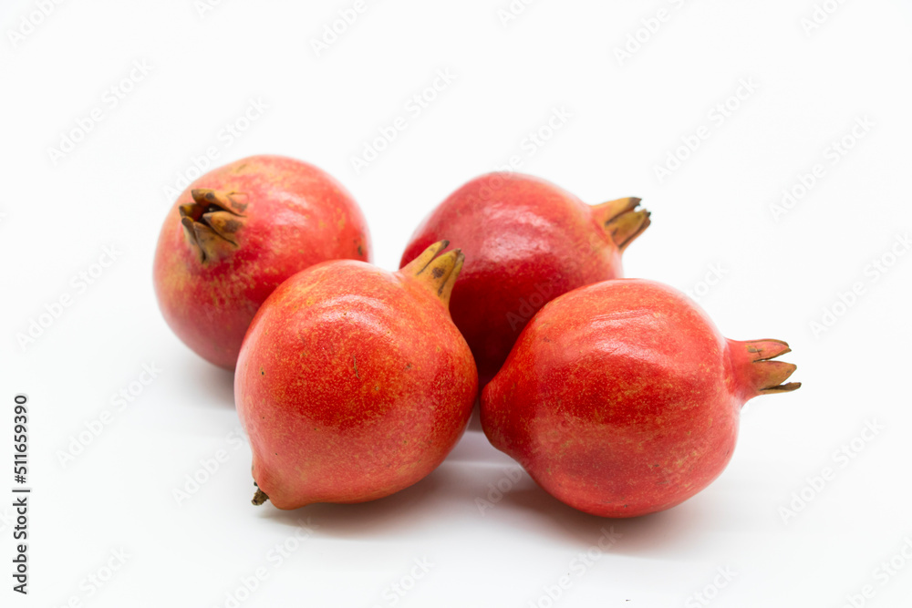 Fresh group of pomegranate closeup isolated on white background. Fresh group of pomegranate closeup isolated on white background.