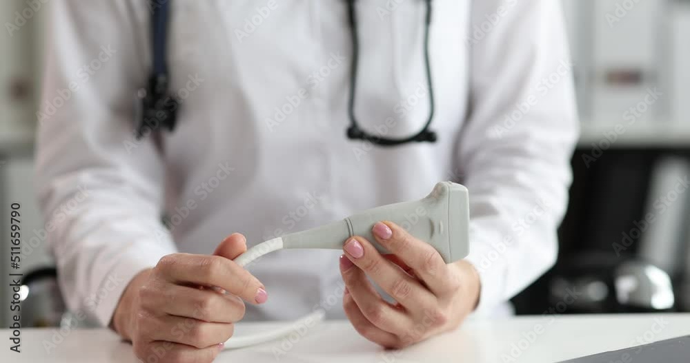 In the hands of a doctor, a sensor for conducting ultrasound In the hands of a doctor, a sensor for conducting ultrasound