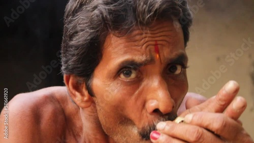 Indian Village man taking or smoking Chilum (Marijuana, Cannabis).A chillum, Chilam Or Chillam is a Earthenware Outside Fitting Hookah Mouth Tip, Cannabis, also known as marijuana among other names. photo