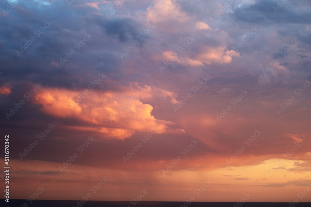 Sunset sky. Pink and blue clouds. Sky with dark clouds