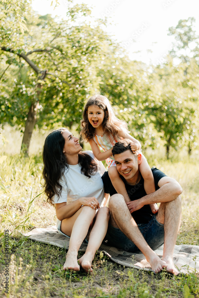 Family resting in nature sitting on the grass