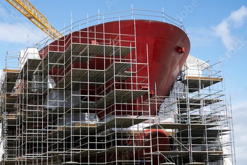 Shipbuilding and crane during ferry construction surrounded by scaffold photo