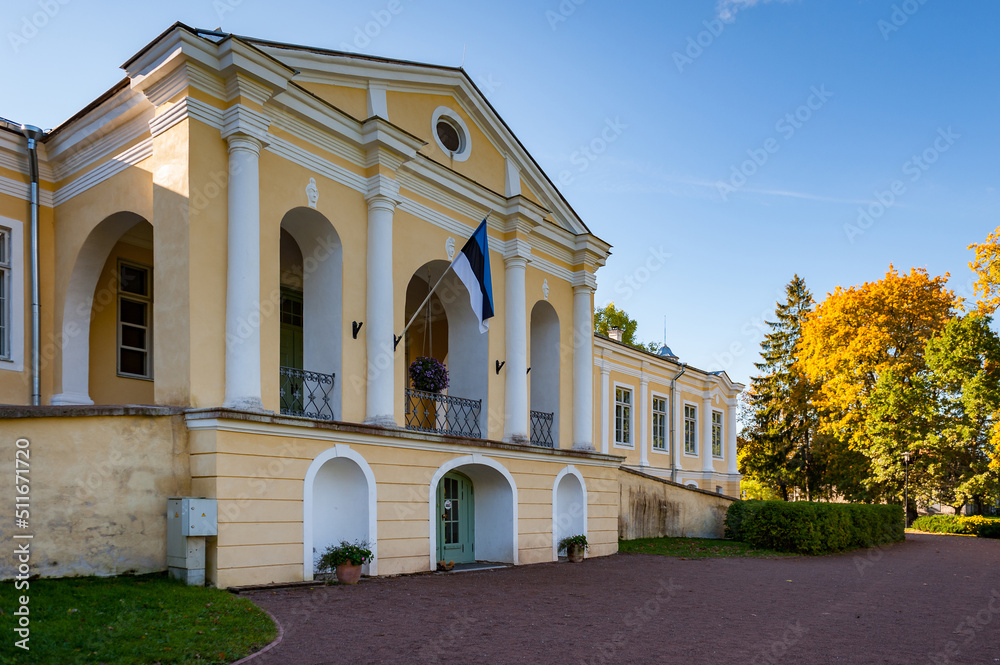 Vääna, Estonia - September 26, 2021: Main entrance to the estate and school. Front facade of Vääna Manor. Sunny autumn weather drew  visitors to enjoy the beautiful manor.