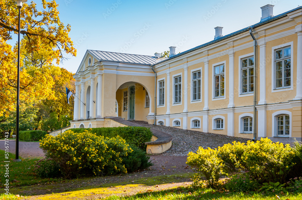 A fragment of the facade with the Estonian national flag and main entrance. Vääna Manor, Estonia. Main building now houses a school.