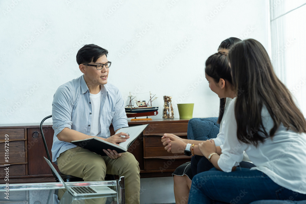 Psychologist man talking and making note to seek advice problems with group of stressed women. Psychologist man talking and making note to seek advice problems with group of stressed women.
