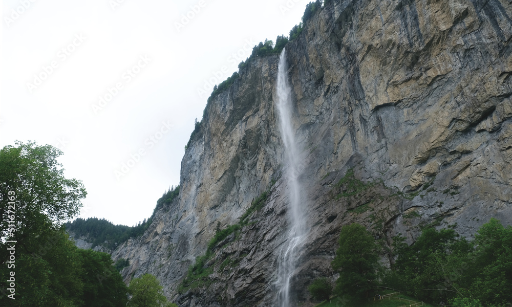 Selective focus picture of water from Staubbach Falls with rocky mountain at Lauterbrunnen. Famous tourism in Switzerland.