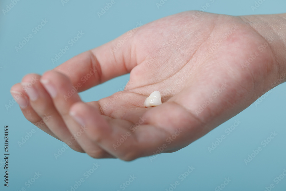 Child's hand holding first tooth milk, Dentistry and Health care concept Child's hand holding first tooth milk, Dentistry and Health care concept