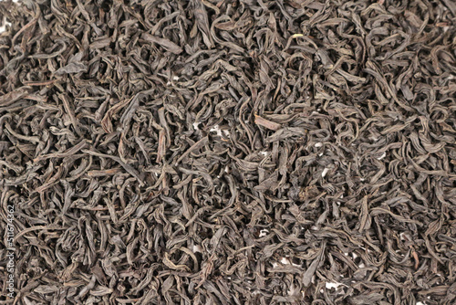 Black tea leaves spread on surface background