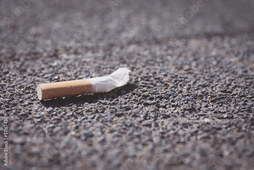 single cigarette stub on the street photo
