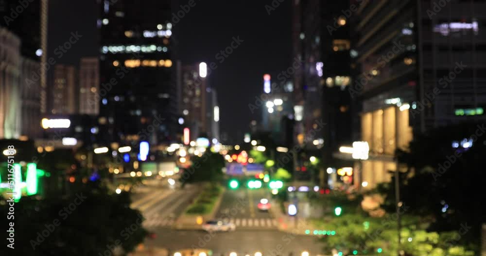 Defocused traffic at night on city road in downtown of shenzhen city,China