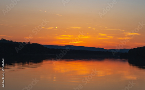 Spectacular sunset on the Danube. Forest, river and a beautiful sunset.
