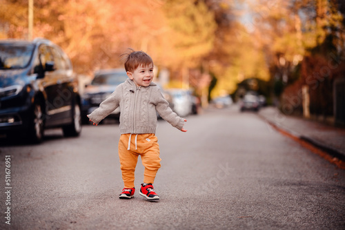 Little toddler boy walking down the street in spring-autumn outfit © Иванна Емельянова