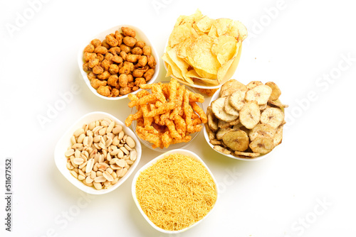 Indian snack peanuts,chips,kurkure,sev in bowl on white background.