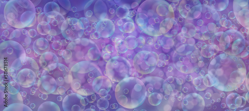 Lots and lots of bubbles in lilac background banner - wide multi layered and multicoloured bubbles in many sizes giving a lilac purple overall effect 