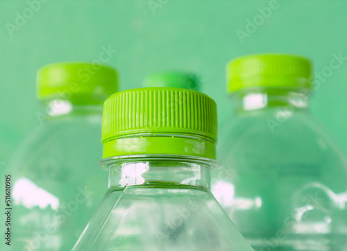 Detail of plastic bottle against green background.