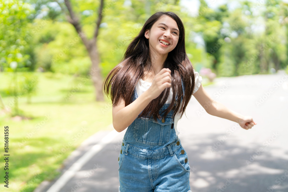 Pretty attractive girl walking and smile with many action in the garden with blur greenery background on sunny day. Happiness during vacation. Relaxation, Aromatherapy freedom feeling lifestyle Pretty attractive girl walking and smile with many action in the garden with blur greenery background on sunny day. Happiness during vacation. Relaxation, Aromatherapy freedom feeling lifestyle