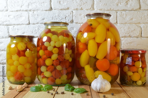 Pickled tomatoes. Stelanny jars with cherry tomatoes. Tomato juice. Cherry red, yellow, white. photo