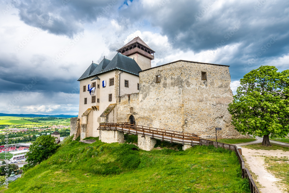 Ancient castle Trencin, Slovakia. Old fort on the hill, big walls and towers. Summer day, dramatic clouds before storm.
