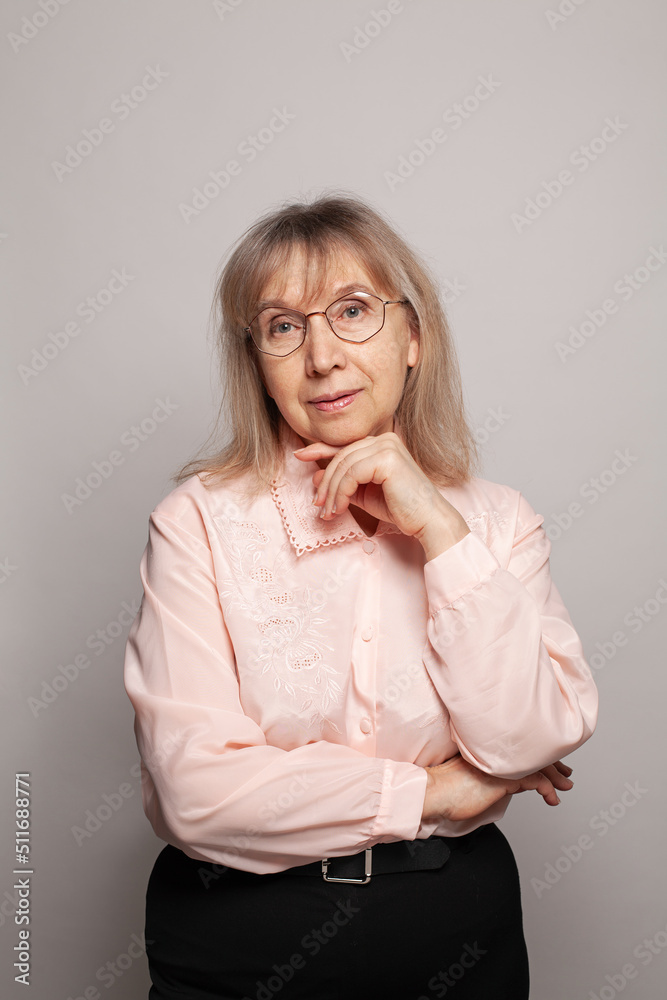 Happy old woman in glasses looking at camera on white background Happy old woman in glasses looking at camera on white background