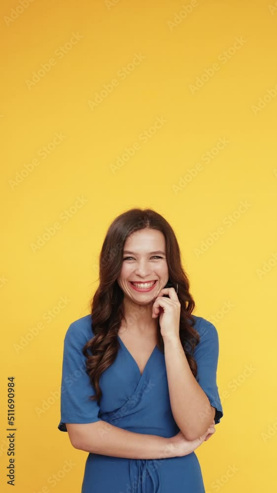 Advertising people. Aha idea. Solution insight. Portrait of pensive inspired woman pointing up finger at something invisible isolated on bright orange copy space vertical background. Advertising people. Aha idea. Solution insight. Portrait of pensive inspired woman pointing up finger at something invisible isolated on bright orange copy space vertical background.