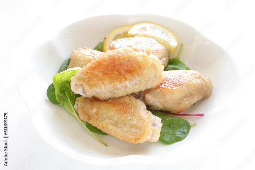 Asian food, Chinese pan fried chicken wings on baby leaves Asian food, Chinese pan fried chicken wings on baby leaves