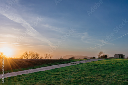 Beautiful sunset over a farm in Uphill  Weston- Super-Mare. Sunset is also known as sundown  is the daily disappearance of the Sun below the horizon due to Earth s rotation.