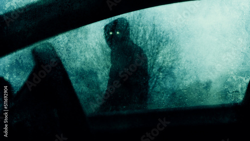 A horror concept of a spooky supernatural figure with glowing eyes. Looking into a car window on a stormy winters evening. With a blurred, textured edit.