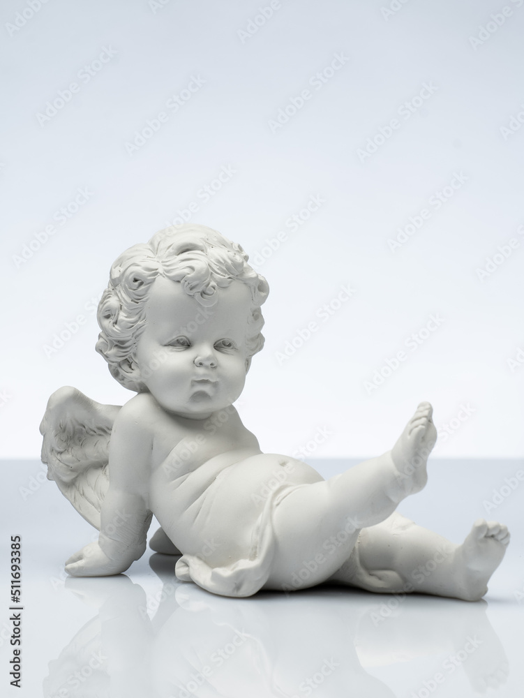 plaster white statuette in the form of an angel on a white background plaster white statuette in the form of an angel on a white background