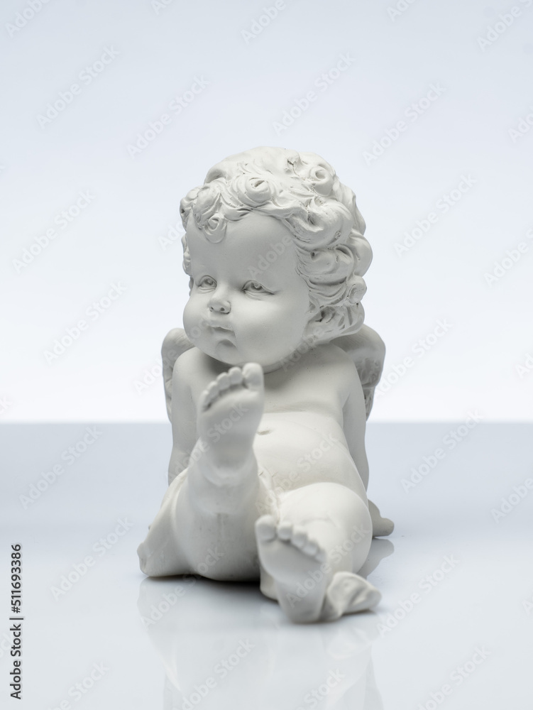plaster white statuette in the form of an angel on a white background plaster white statuette in the form of an angel on a white background