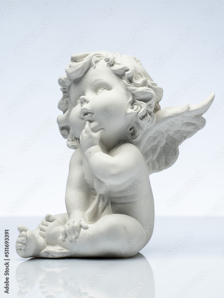 plaster white statuette in the form of an angel on a white background plaster white statuette in the form of an angel on a white background