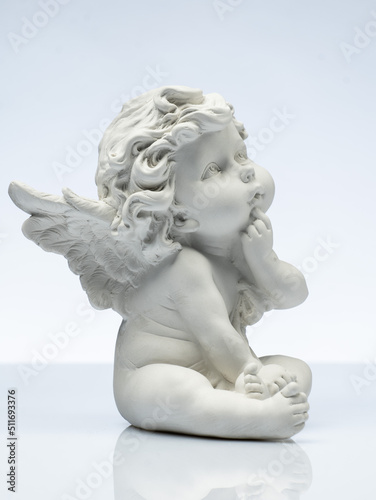plaster white statuette in the form of an angel on a white background Fototapet