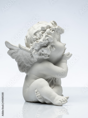 Canvastavla plaster white statuette in the form of an angel on a white background