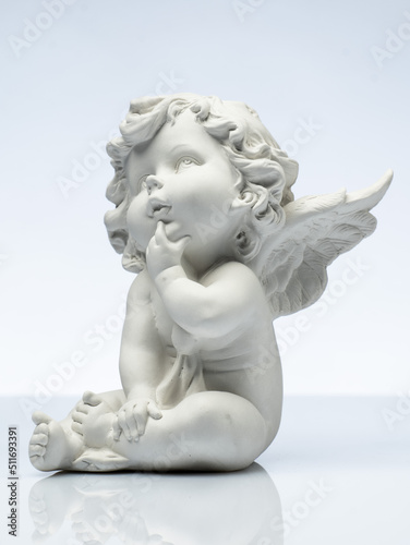 Obraz na plátně plaster white statuette in the form of an angel on a white background