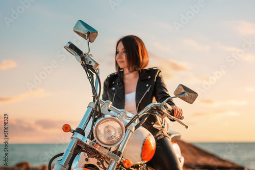 Fotografiet Defocused portrait of a beautiful adult woman driving a motorcycle