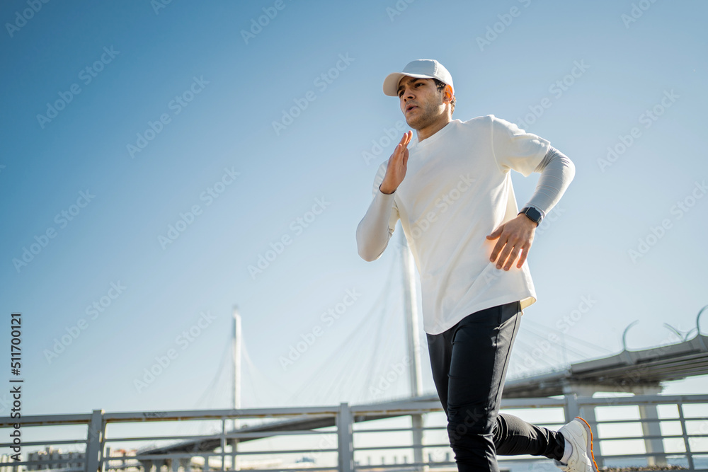 Running male athlete conducts fitness training on the street in the city, Healthy lifestyle Running male athlete conducts fitness training on the street in the city, Healthy lifestyle