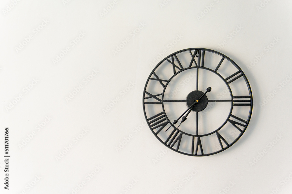 clock on the wall with a Roman dial with copy space clock on the wall with a Roman dial with copy space