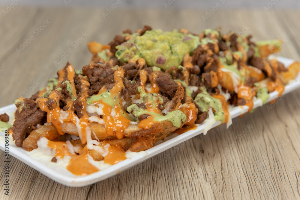 Appetizing carne asada steak french fries for a tempting Mexican food delicacy Appetizing carne asada steak french fries for a tempting Mexican food delicacy