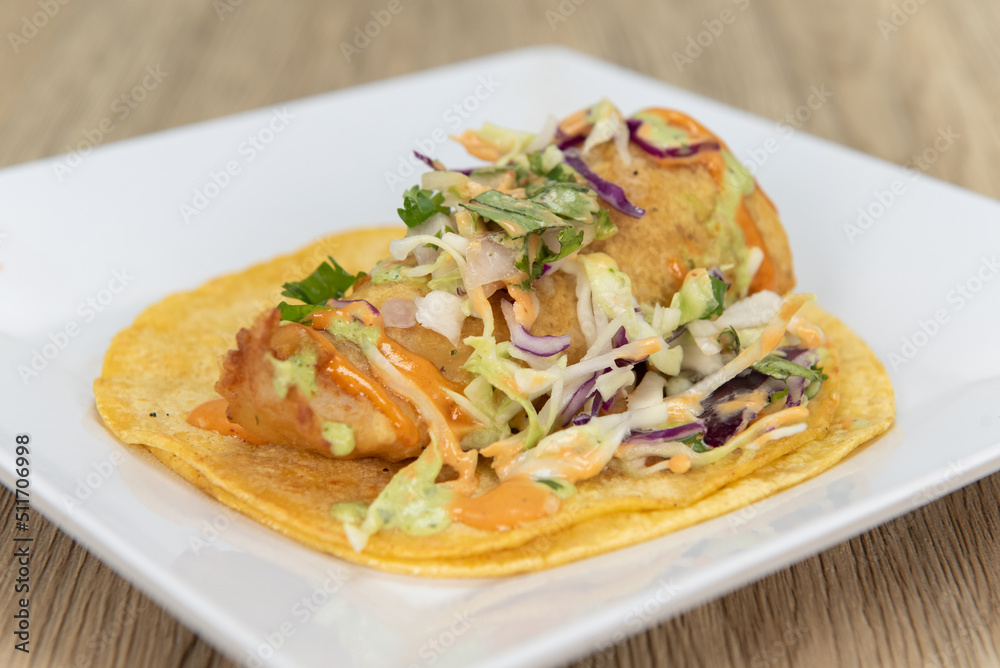 Appetizing fish taco with perfect presentation for a tempting Mexican food delicacy Appetizing fish taco with perfect presentation for a tempting Mexican food delicacy