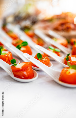 salmon appetizers served with white spoons,including smoke salmon rolls and cheese. buffet or catering. photo
